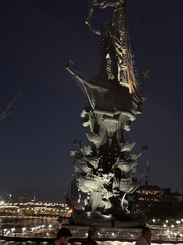 Evening gathering at illuminated Peter the Great Monument in Moscow