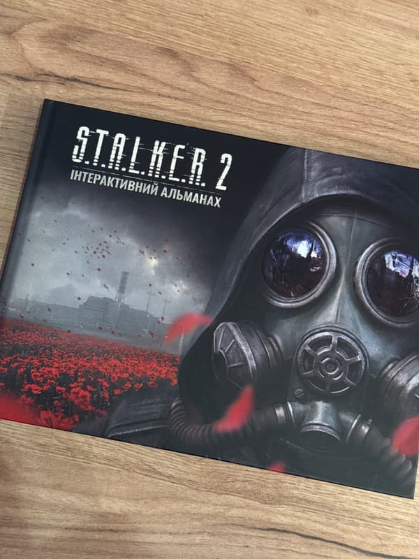 Person unboxes S.T.A.L.K.E.R. 2 trading cards in Kyiv