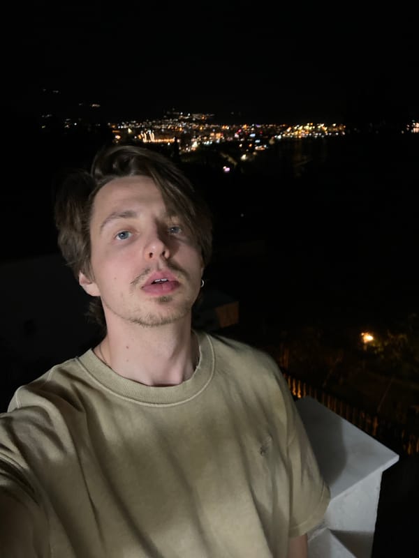 Man takes selfie in Šušanj, Montenegro evening setting