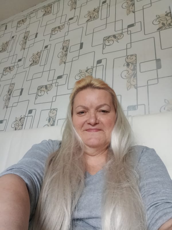 Woman photographed sitting indoors in Красный Маяк, Russia