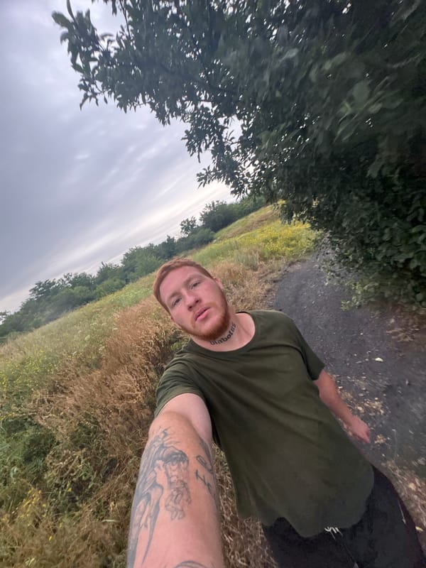 Selfie series outdoors, overcast rural setting, green t-shirt