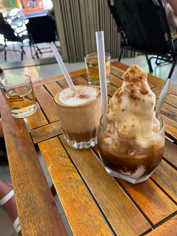 Glass containers with brown liquid photographed on Đà Nẵng table
