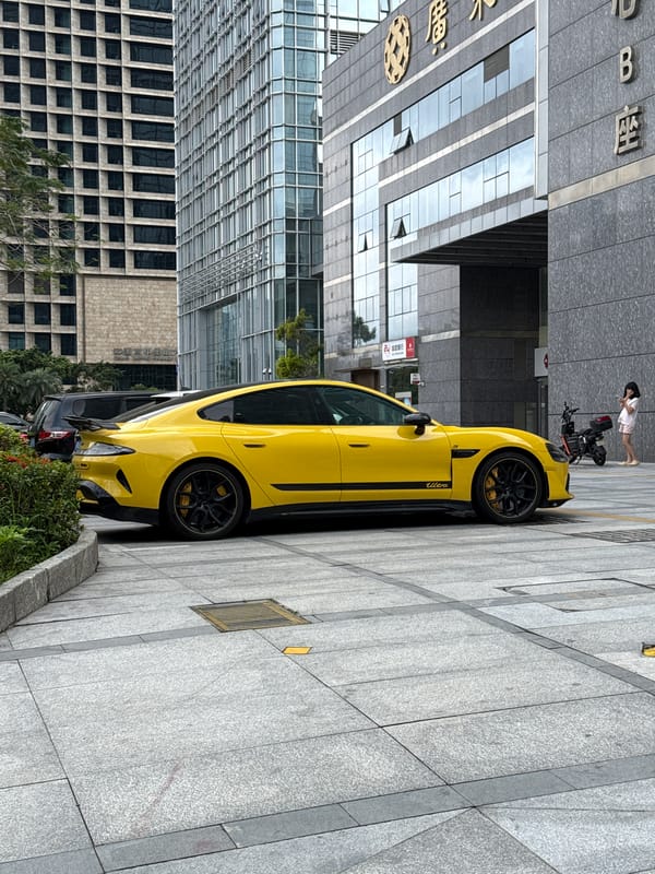 Yellow Porsche parked near modern buildings in Futian District