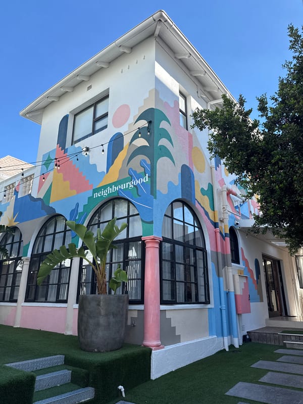 Cape Town afternoon scenes: paraglider, mural, parked Porsche observed