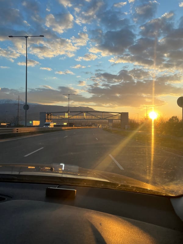 Highway journey through mountains captured in dramatic lighting