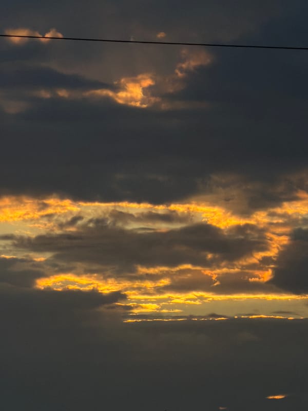 Dramatic sunset clouds over Gorzów, with a cold drink inside
