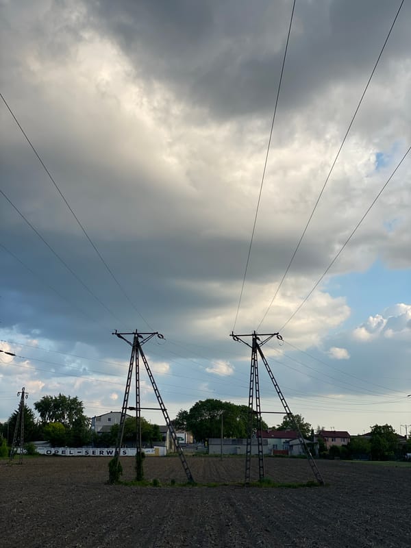 Power transmission lines documented near plowed field in Poland