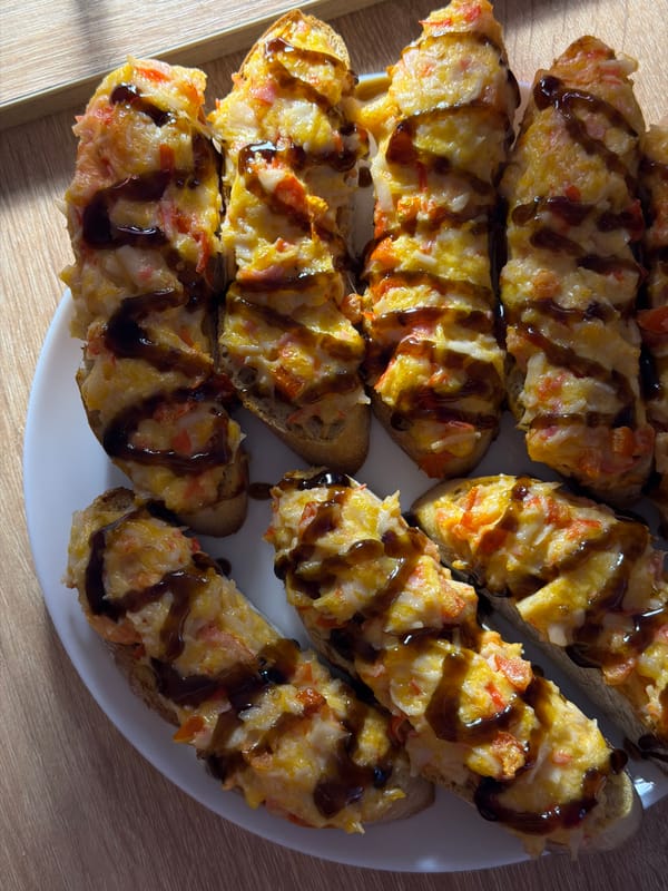 Red wine and toasted appetizers at a casual spread