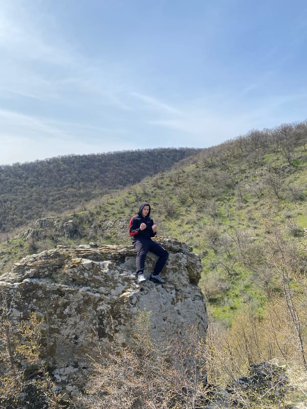 Person rests on rocky outcrop in Goritsa, Bulgaria