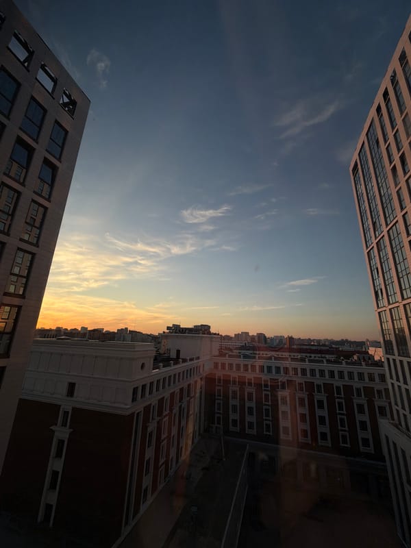 Ufa skyline at golden hour, modern apartments up front