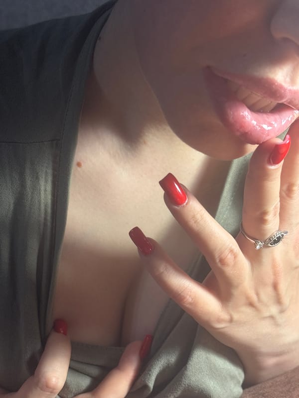 Close-up series: red nails, green top, pink drink