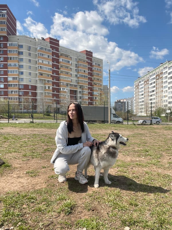 Woman with husky dog enjoys sunny morning in Izhevsk park