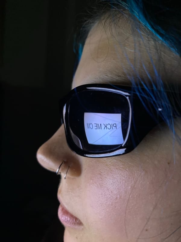 Sunglasses reflect smartphone selfie in Gijón street scene