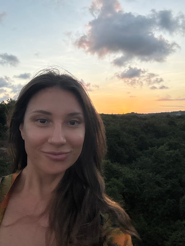 Woman captures sunset moments near Kuta Selatan airport signs