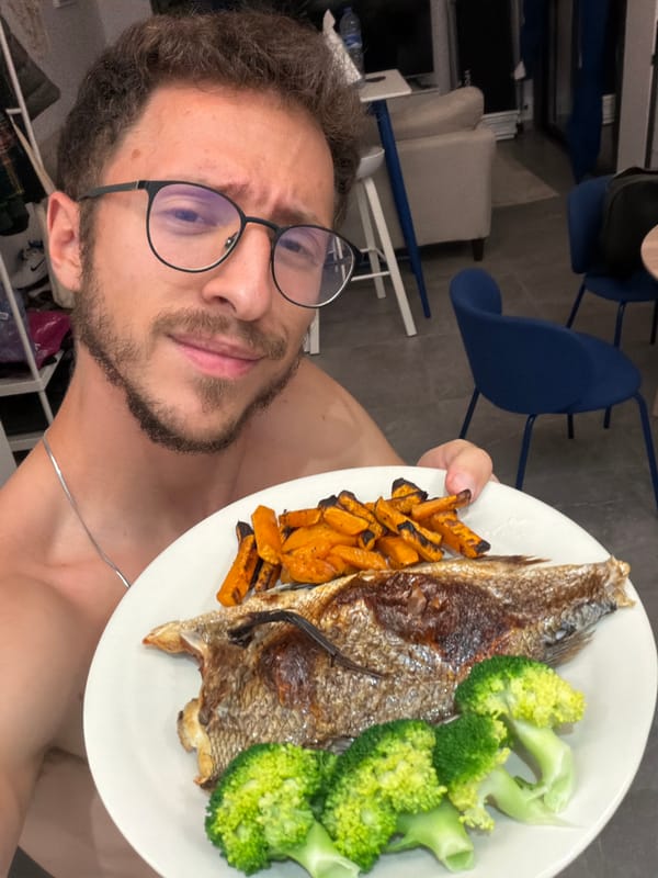 Man displays home-cooked fish dinner in Cyprus kitchen