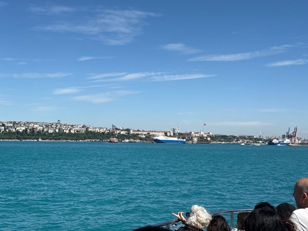 Ferry carries passengers across Bosphorus with Istanbul skyline backdrop