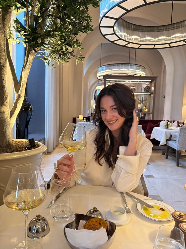 Woman dines at Belgrade restaurant with wine and food