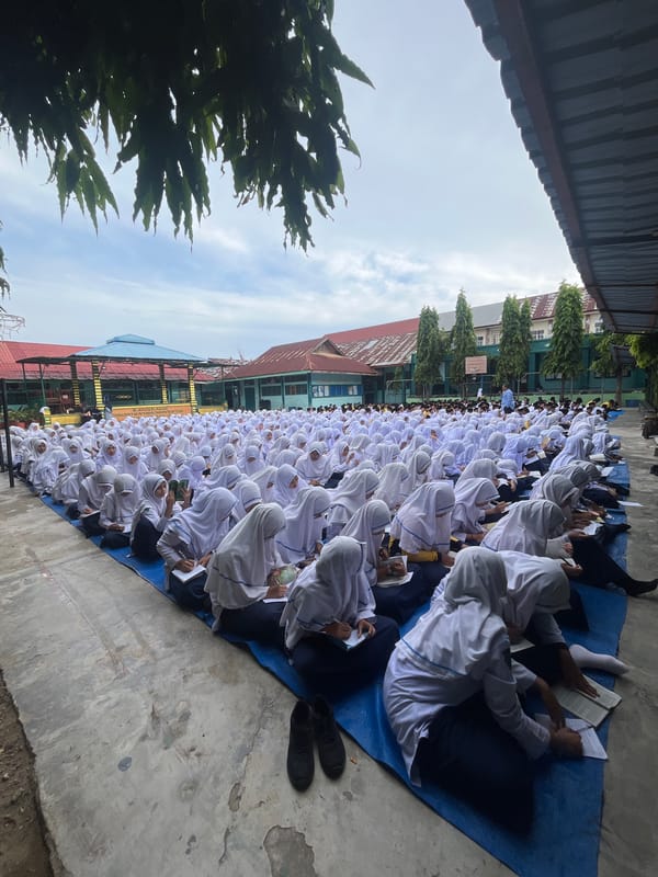 Mass outdoor study session at a Lhokseumawe school courtyard