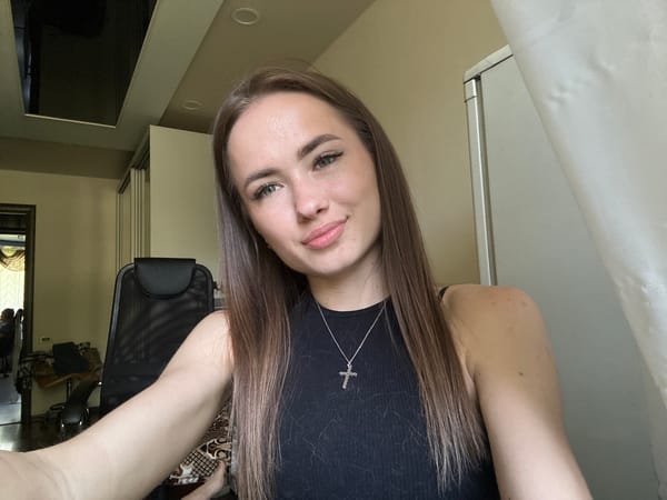 Woman takes selfies, cat spotted in tall grass
