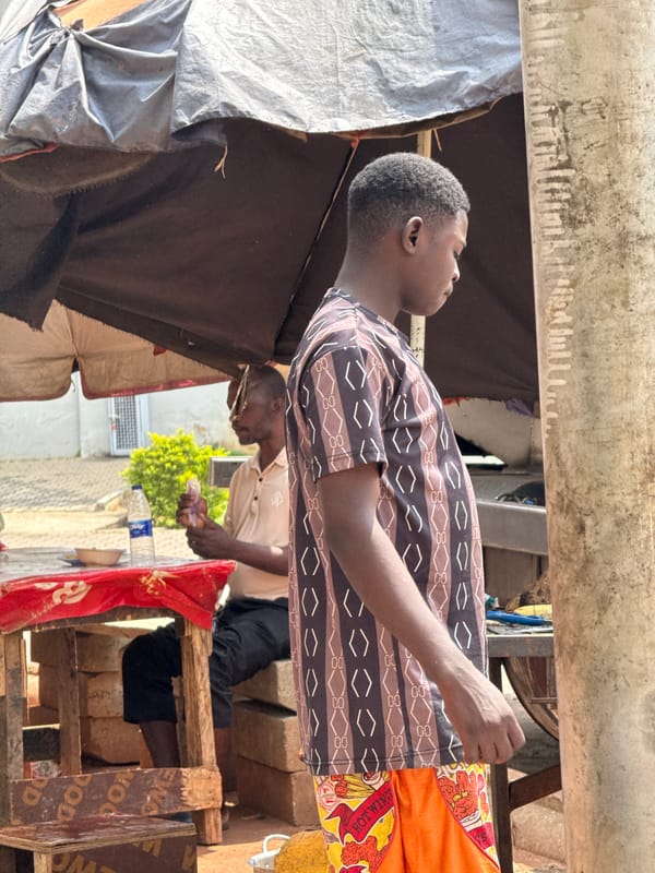 Street market activity at a busy Abuja roadside stall