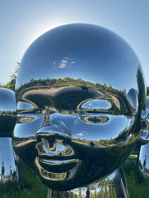 Visitors explore chrome sculpture park in sunny Krasnodar afternoon
