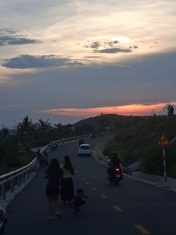 Coastal road gathering at dusk, Phu Thuy Ward, Vietnam