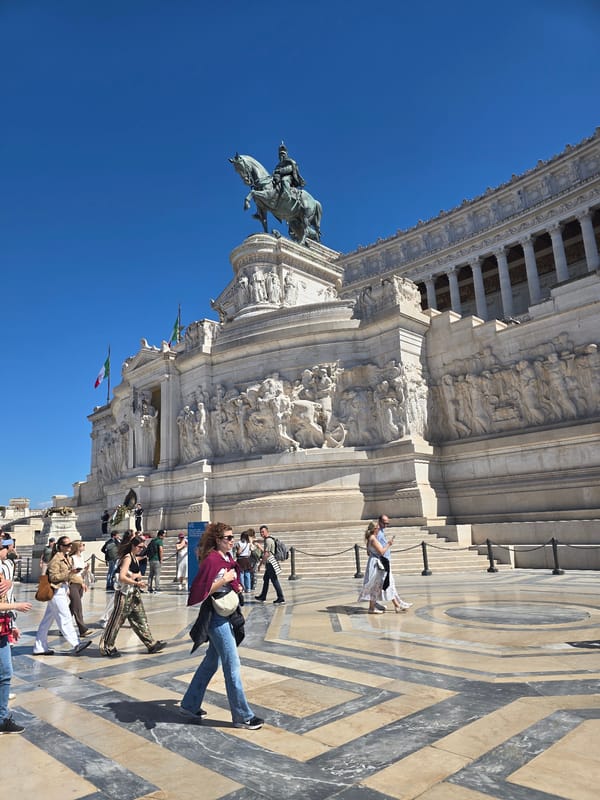 Tourists visit Rome's Victor Emmanuel Monument under clear skies