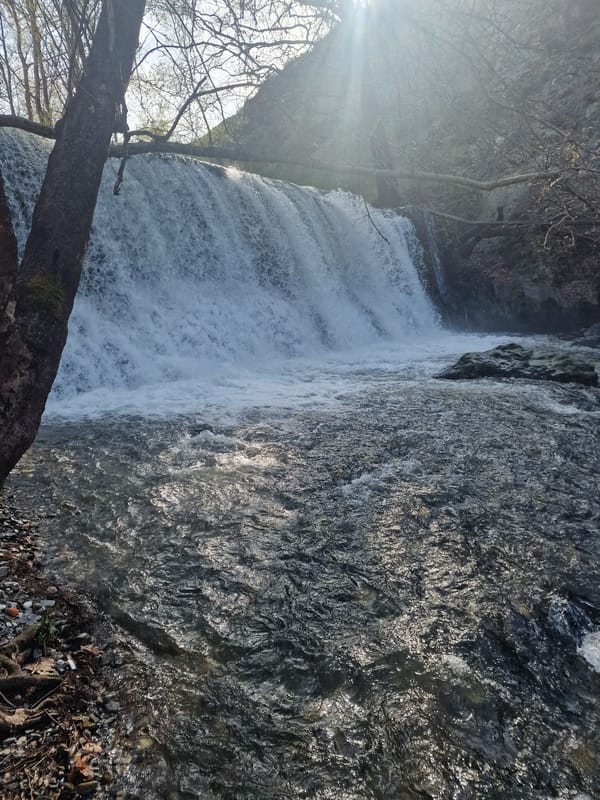 Waterfall flows through rocky landscape in Parvenets, Bulgaria