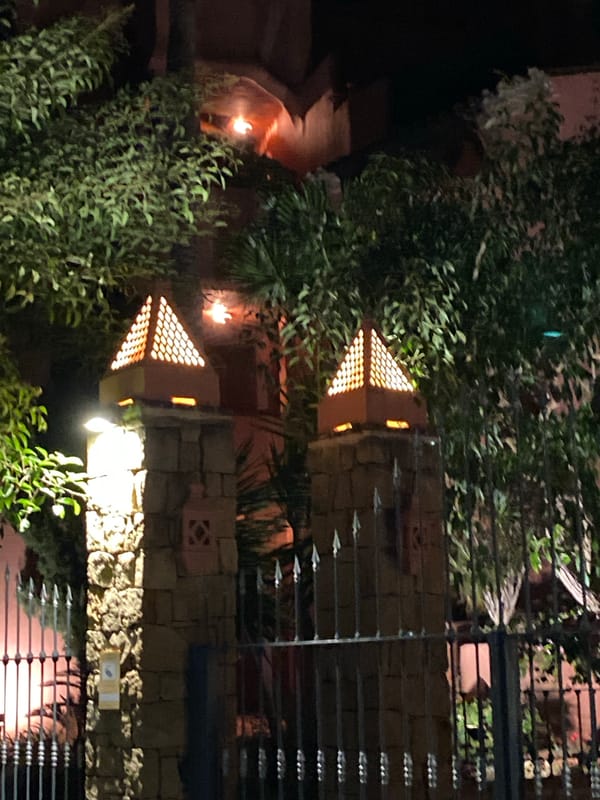 Evening around Estepona's lit gardens, pools, and fountains