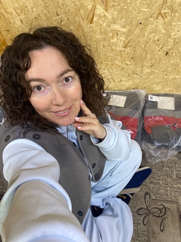 Woman relaxing indoors with pen and mug in Ol'khovskoye