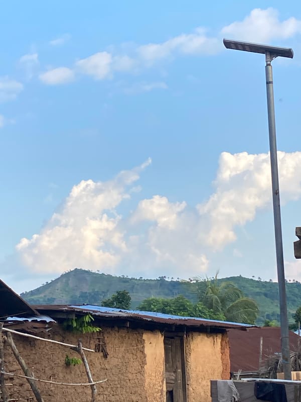 Rural Igbara: mud-brick homes and hills in late afternoon light