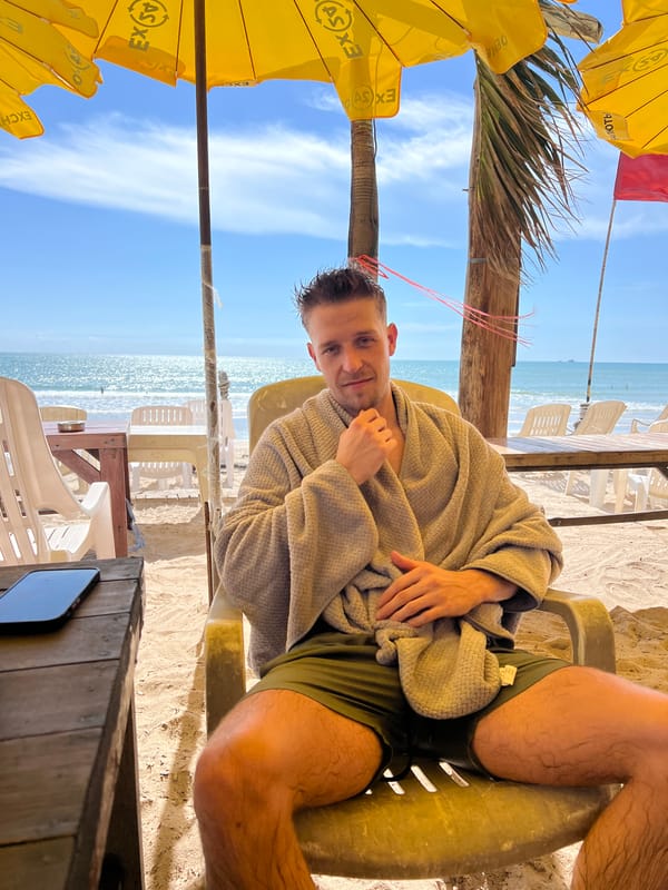 Beach scene captured showing relaxed morning activities under umbrellas