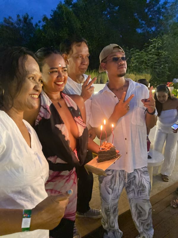 Birthday celebration on a wooden deck in Nusa Penida at dusk