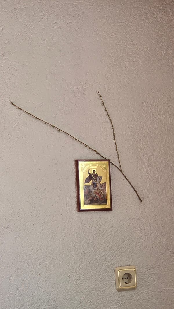 Religious icon displayed on textured wall with mounted items