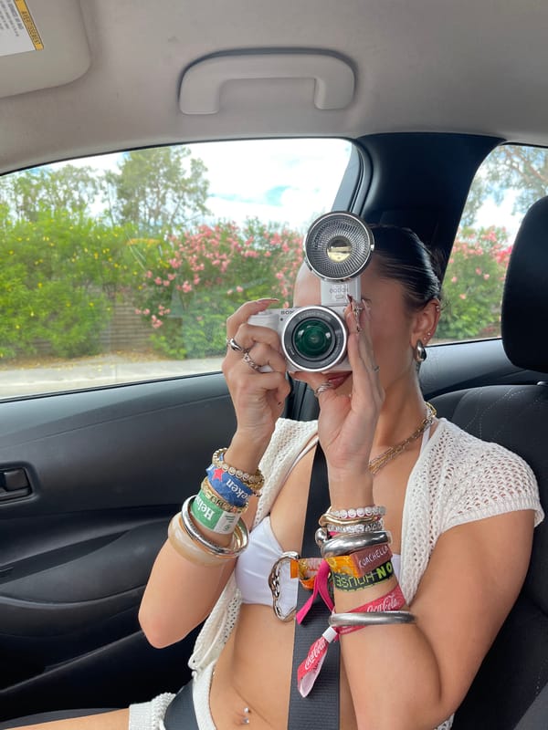 Woman photographing from passenger seat in Palm Springs vehicle