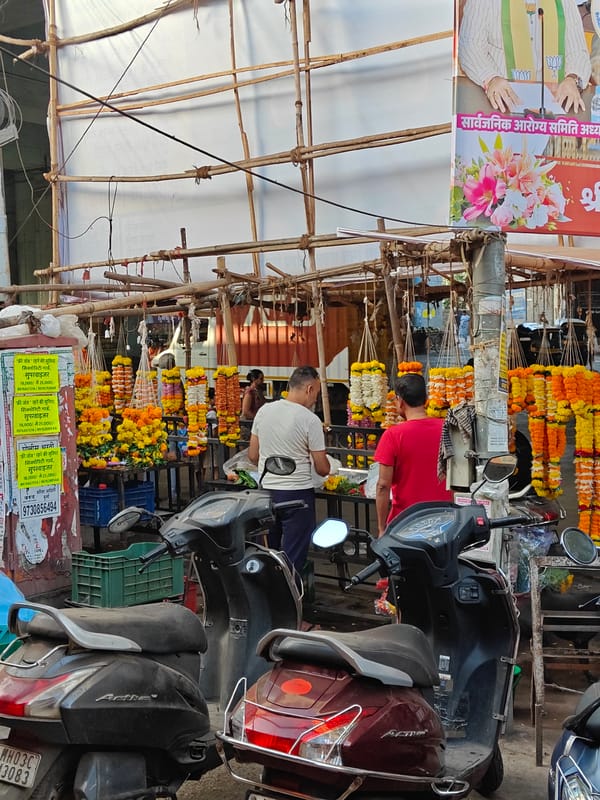 Flower vendors sell marigold garlands on Mumbai street