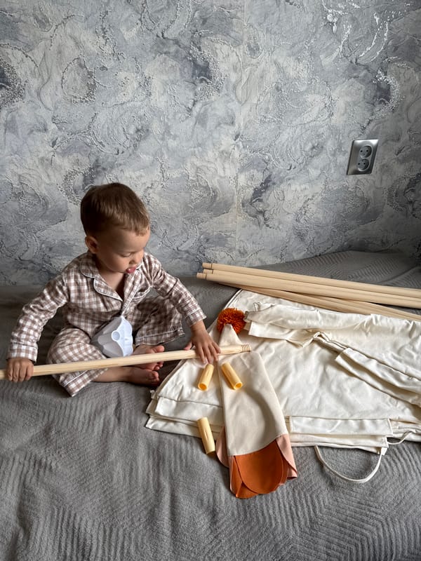 Child plays with tent in pajamas during morning hours