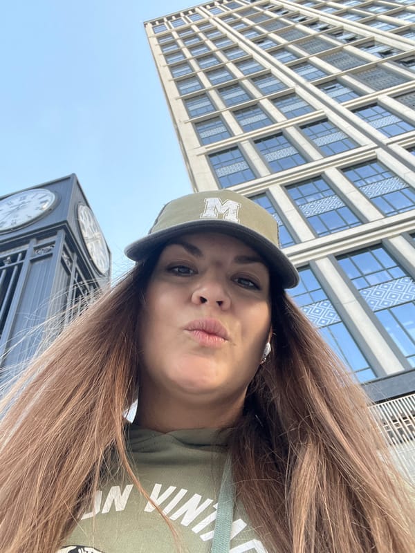Woman takes selfie against tall building in Novosibirsk