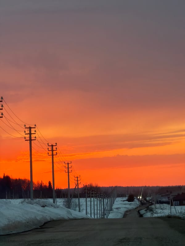 Dramatic sunset captured along snowy road in Izhevsk