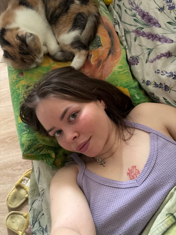 Woman and calico cat share quiet morning moments in Izhevsk