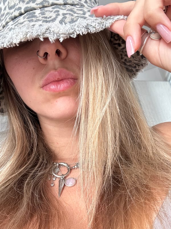 Leopard-print bucket hat pulled low over the face