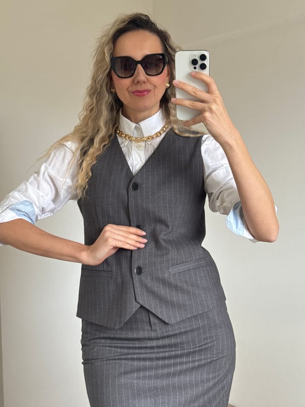 Woman in pink photographed against brick wall in Carnikava