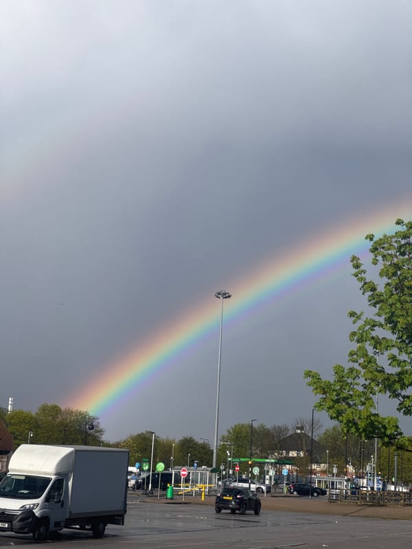 Rainbow appears over London on cloudy afternoon