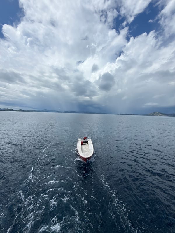 Motorboat towed across choppy waters near Pasir Putih, Indonesia