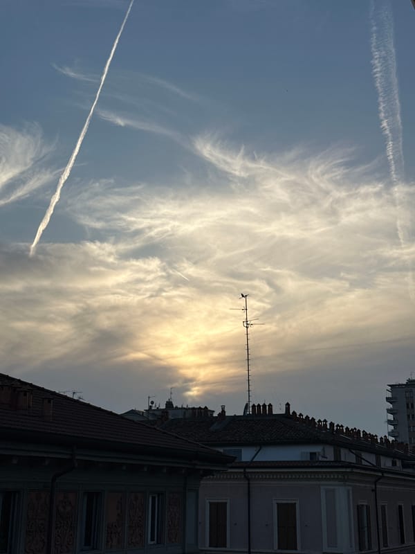 Milan skyline view captured showing red-roofed building with antenna
