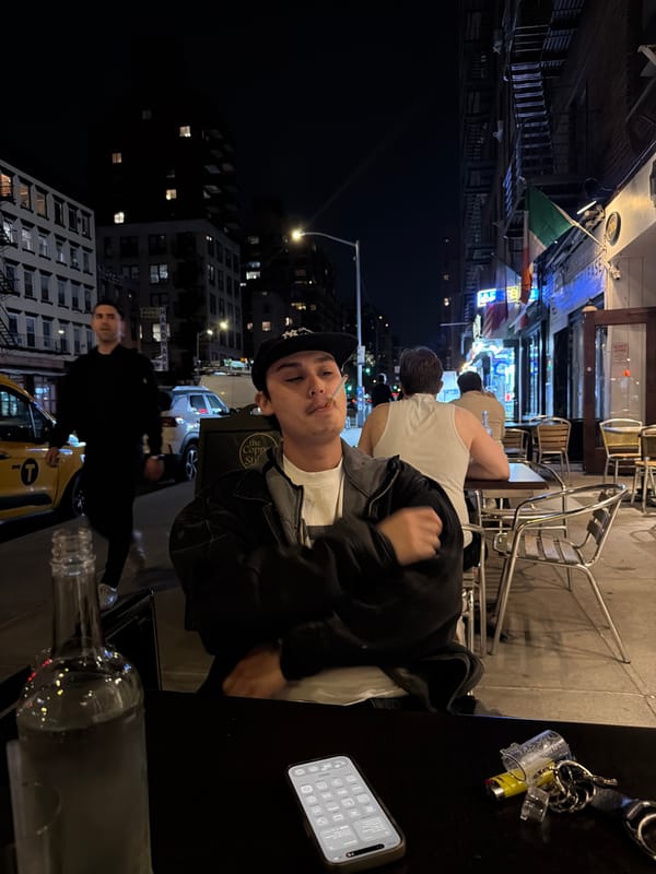 Person seated outdoors at night in New York City