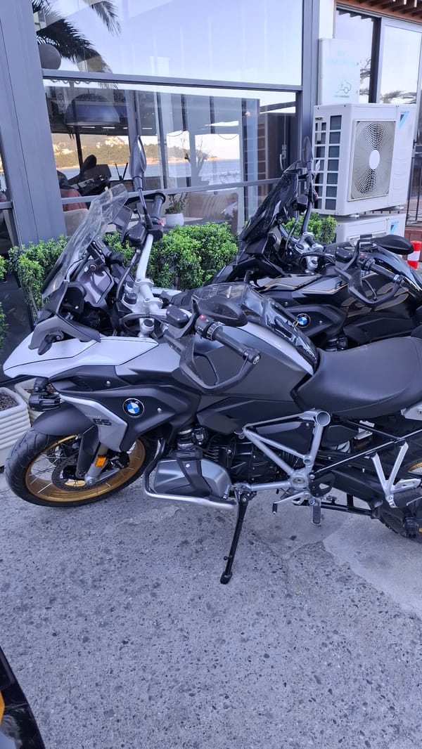 Two BMW motorcycles parked in coastal Montenegro town