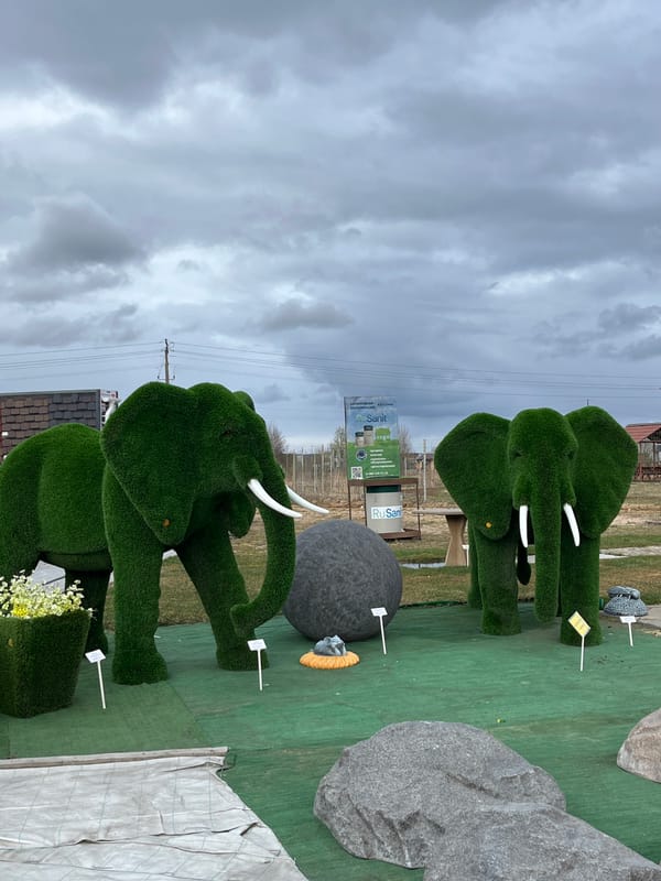 Decorative animal sculptures displayed in outdoor Bezborodovo garden setting