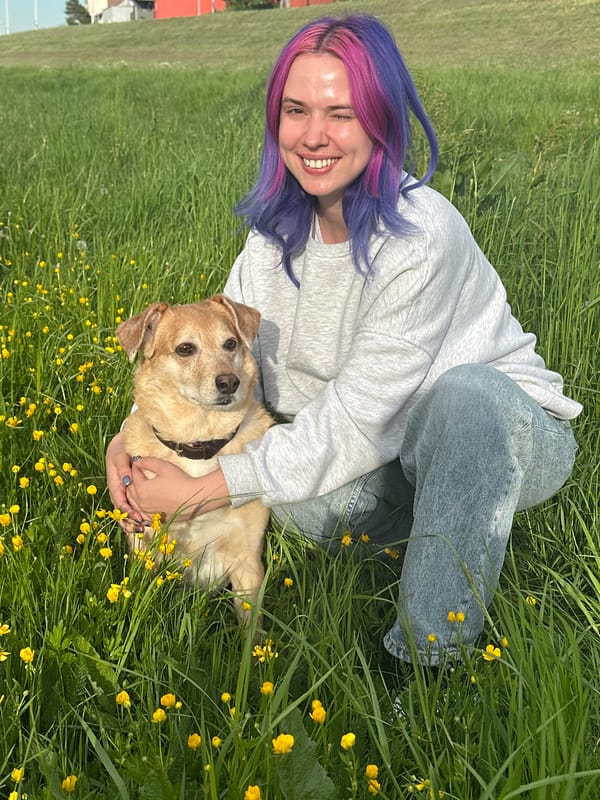 Woman enjoys sunny afternoon with dog in Zagreb field