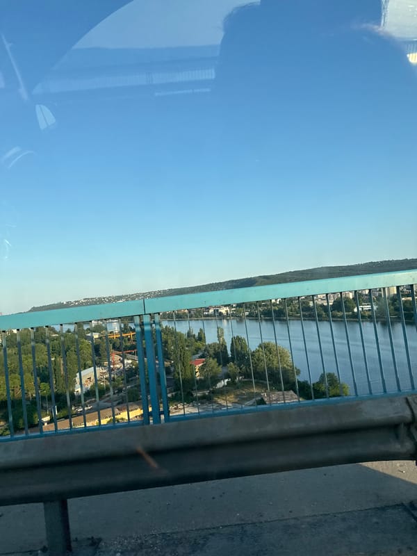 Sunny bridge crossing with city skyline and port views